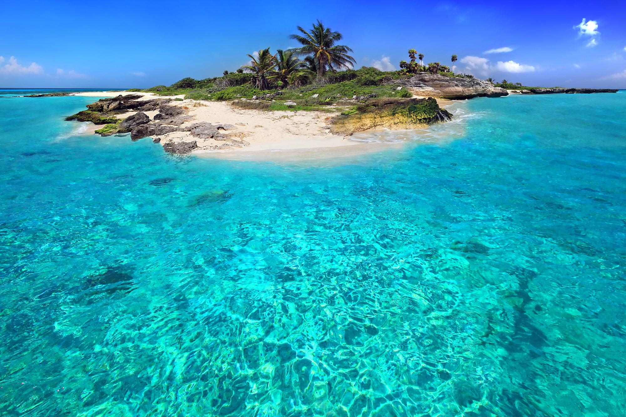 Caribbean island surrounded by clear blue waters