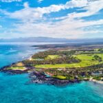 The lush coast of the Big Island jutting out into the ocean.